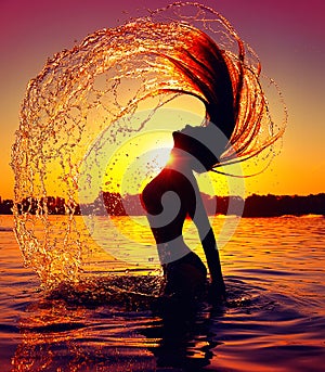 Beauty splashing water with her hair