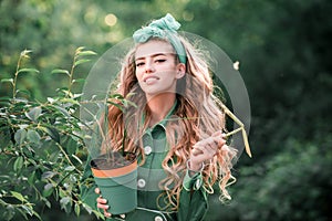 Beauty spring girl with flower pot. Springtime.