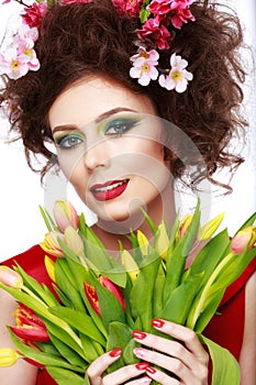 Beauty Spring Girl with Flowers Hair Style. Beautiful Model woman with Blooming flowers on her head. Nature Hairstyle. Summer. Ho