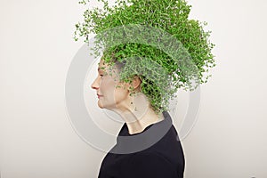 Beauty Spring Woman with Fresh Green Thyme Hair. Summer Nature Girl portrait.