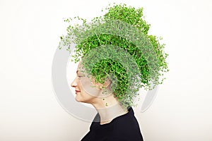 Beauty Spring Woman with Fresh Green Thyme Hair. Summer Nature Girl portrait.