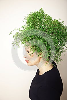 Beauty Spring Woman with Fresh Green Thyme Hair. Summer Nature Girl portrait.