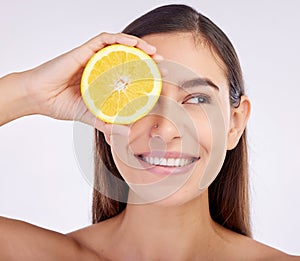 Beauty, studio face and happy woman with lemon for skincare glow, vitamin c detox and natural facial exfoliation. Fruit