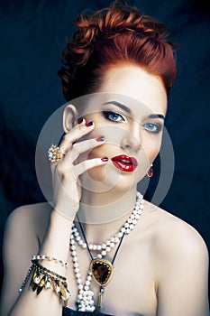 Beauty stylish redhead woman with hairstyle and manicure wearing jewelry pearl close up