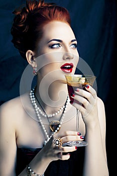 Beauty stylish redhead woman with hairstyle and manicure wearing jewelry pearl close up