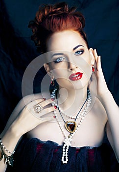 Beauty stylish redhead woman with hairstyle and manicure wearing jewelry pearl close up