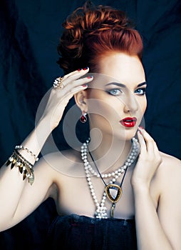 Beauty stylish redhead woman with hairstyle and manicure wearing jewelry pearl close up