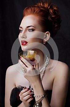 Beauty stylish redhead woman with hairstyle and manicure wearing jewelry pearl close up