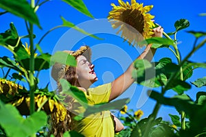 beauty of summer nature. little girl in sunflower field. yellow flower of sunflower. happy childhood. beautiful girl