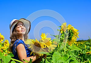 Beauty of summer nature. little girl in sunflower field. yellow flower of sunflower. happy childhood. beautiful girl