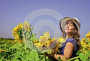 beauty of summer nature. little girl in sunflower field. yellow flower of sunflower. happy childhood. beautiful girl