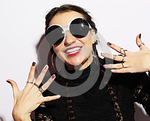 Beauty surprised fashion model girl wearing big sunglasses. Young girl. Makeup. Over white background.