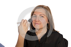 Beauty technician applying makeup on client