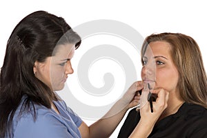 Beauty technician applying makeup on client