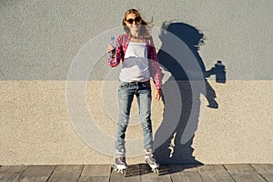 A beauty teen model girl, shod in rollerblades holding a water b