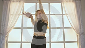 Beauty Teenage Girl Dancing. Against the background of a window in the form of a cage, cubes and squares. Joyful Teen