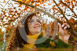 beauty and tenderness in the look and even white-toothed smile at the dark-haired curly girl against the background of