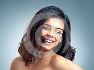 Beauty thats flawless and faultless. Studio shot of a beautiful young woman posing against a gray background. photo