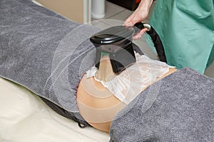 Beauty therapist applying cryolipolysis treatment. Non-surgical fat reduction