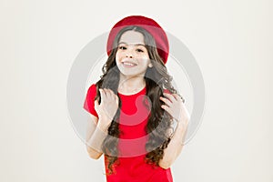 Beauty tips for tidy hair. Smiling child. Kid girl long healthy shiny hair wear red hat. Little girl with long hair. Kid