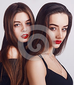 Beauty too womans face Portrait. Brunette female looking at camera. Youth and make-up Concept. on a white background.