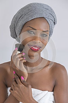 Beauty and tradition. Studio shot of a beautiful African woman wearing headscarf looking to the side smiling