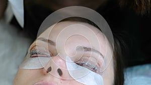 Beauty treatment. Beautician put a solution on curler eyelash curler used brush. Botox and lash lamination. Closeup eyes