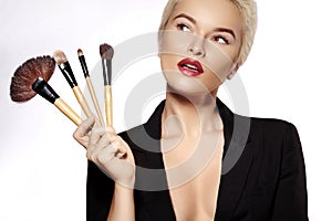 Beauty Treatment. Girl with Makeup Brushes. Fashion Make-up for Woman. Makeover. Make-up Artist Applying Visage