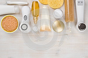 Beauty treatment products on wooden background with copyspace at bottom