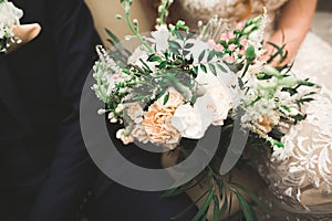 Beauty wedding bouquet with different flowers in hands