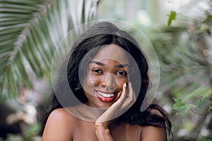 Beauty and wellness concept. Young and beautiful African woman with maked shoulders, perfect smooth skin, natural make