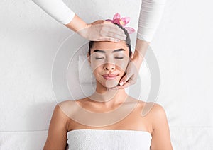 Beauty And Wellness. Young Asian Woman Enjoying Face Lifting Massage In Spa