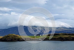 Beauty of wild nature. Mountain coast and sea under cloudy sky in Rejkjavik, Iceland. Mountain landscape on cloudscape