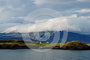 Beauty of wild nature. Mountain coast and sea under cloudy sky in Rejkjavik, Iceland. Mountain landscape on cloudscape