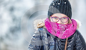 Beauty Winter Girl Blowing Snow in frosty winter park or outdoors. Girl and winter cold weather