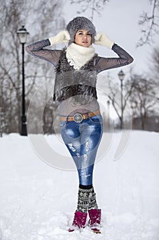Beauty Winter Girl in frosty winter Park. Outdoors. Flying Snowflakes. Joyful Beauty young woman Having Fun in Winter Park.
