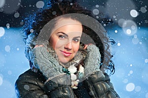 Beauty winter portrait of young attractive woman over snowy Christmas background
