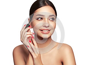 Beauty woman applying black mascara on eyelashes