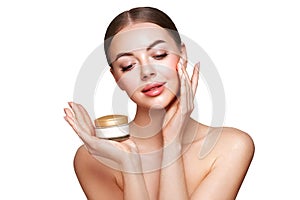 Beauty woman applying cream on her face photo