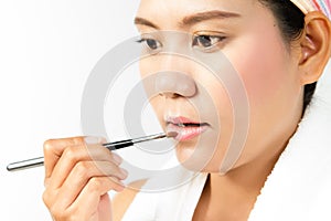 Beauty woman applying lipstick