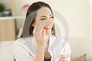 Beauty woman applying moisturizer cream on the face