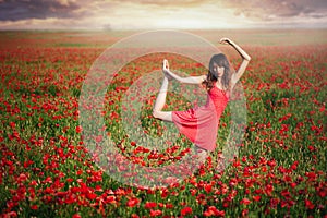 Beauty woman in ared dress dancing poppy field at sunset, cleanliness and innocence, unity with nature