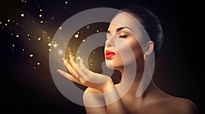 Beauty woman blowing magic dust with golden hearts