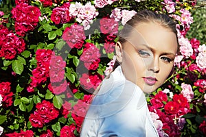 Beauty woman with bunch rose flowers. Professional Makeup