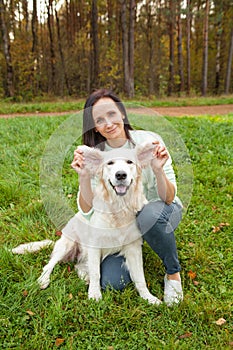 Beauty woman with dog, funny portrait outdoors in the park