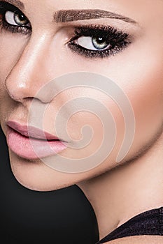 Beauty Woman Face. Closeup Of Beautiful Young Female Model With Soft Smooth Skin And Professional Facial Makeup. Beautiful woman