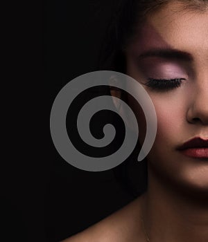 Beauty woman face closeup isolated on black background.