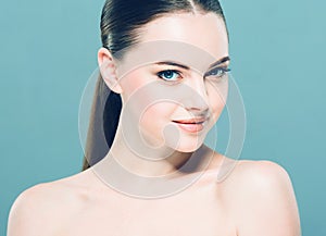 Beauty Woman face Portrait. Beautiful Spa model Girl with Perfect Fresh Clean Skin. Blue background.