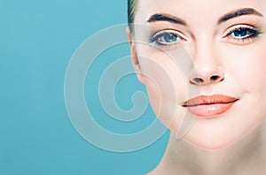 Beauty Woman face Portrait. Beautiful Spa model Girl with Perfect Fresh Clean Skin. Blue background.