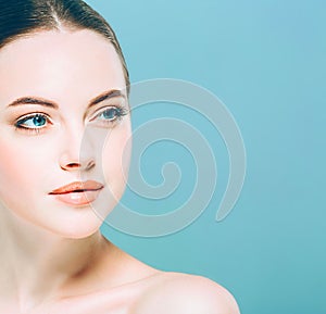 Beauty Woman face Portrait. Beautiful Spa model Girl with Perfect Fresh Clean Skin. Blue background.